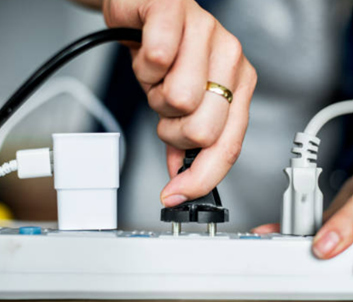 plug being inserted into a surge protector